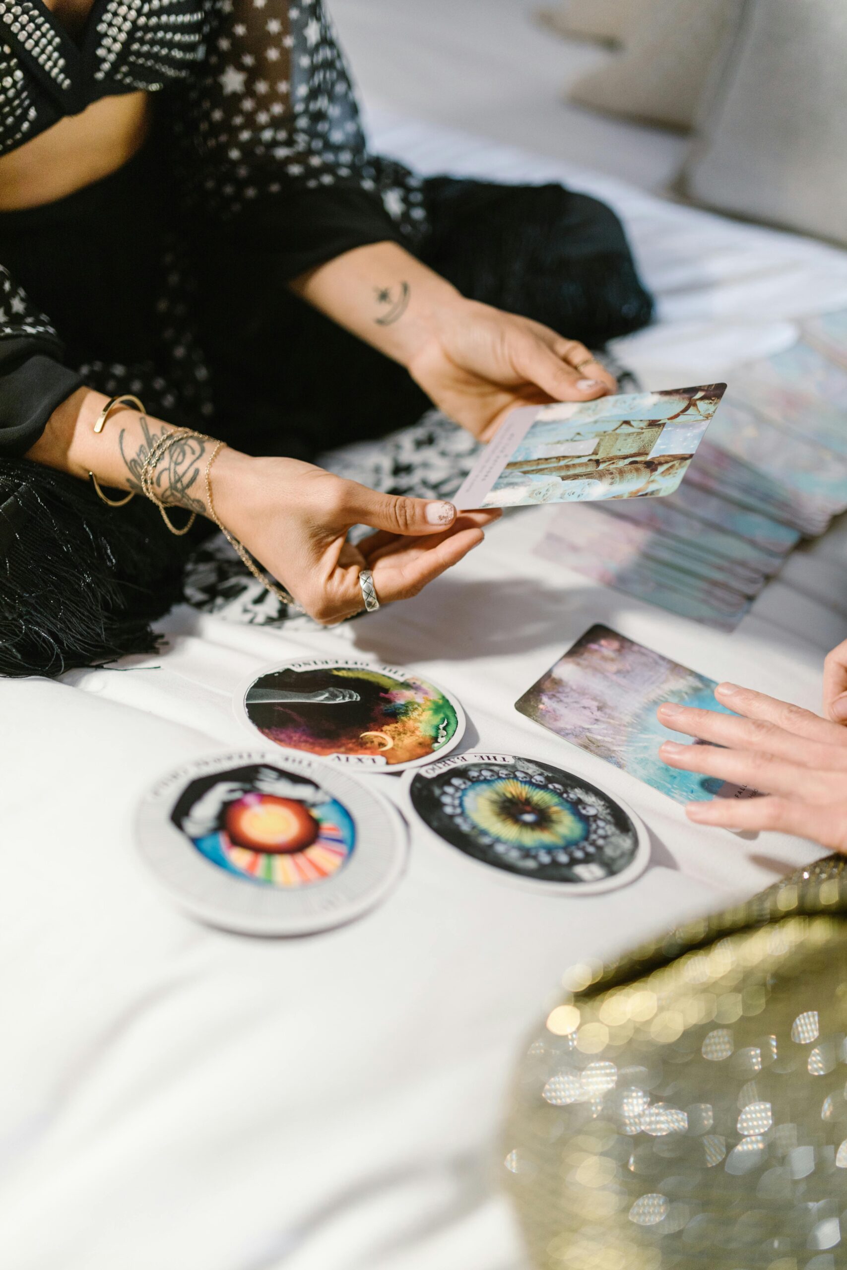 Two people engaging in a tarot card reading session with colorful cards and spiritual symbols.